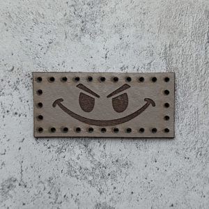 Evil smiley face leather patch