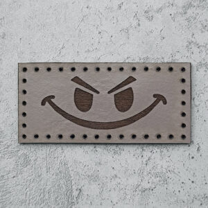 Evil smiley face leather patch