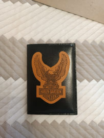 Leather eagle patch with Harley-Davidson logo on the cover of documents